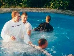 Pool party with students in wet clothes.